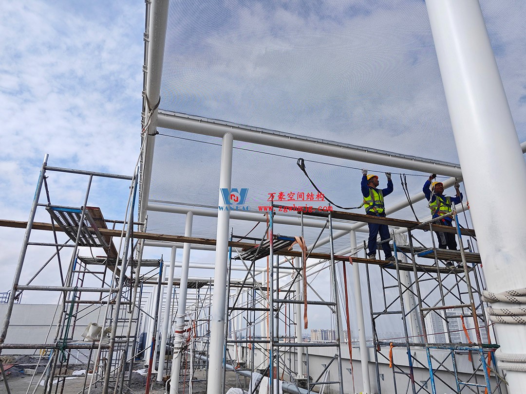 聚焦工程高質(zhì)量建設，這個網(wǎng)格織物幕墻正在施工安裝中